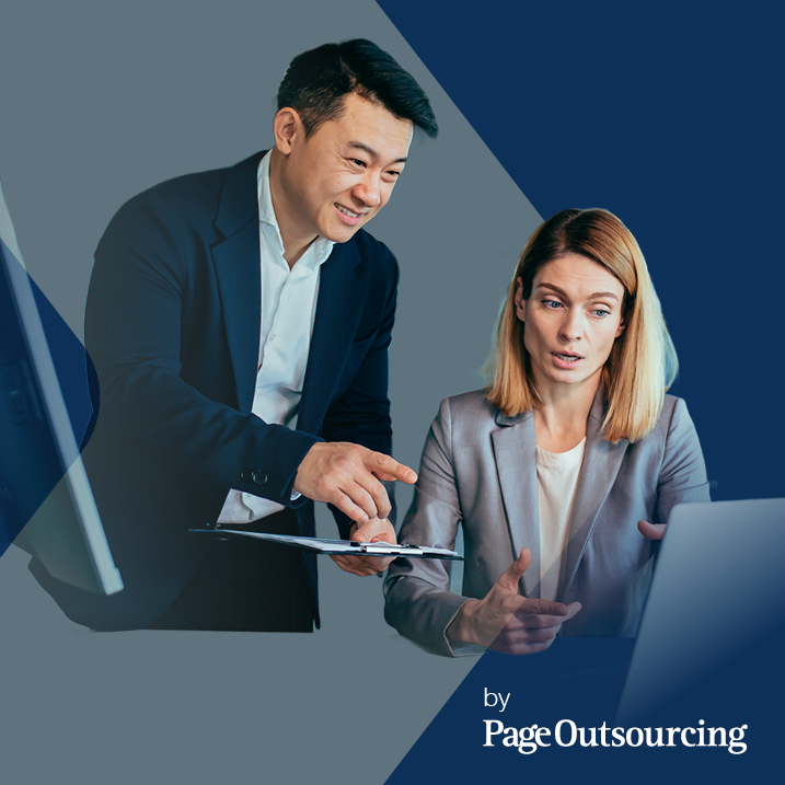 a woman and a man talking and pointing a computer 