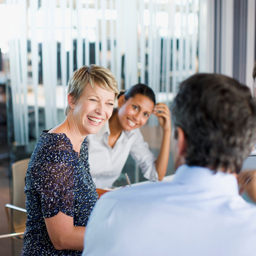 Professionals engaged in a discussion during a meeting in a modern office.