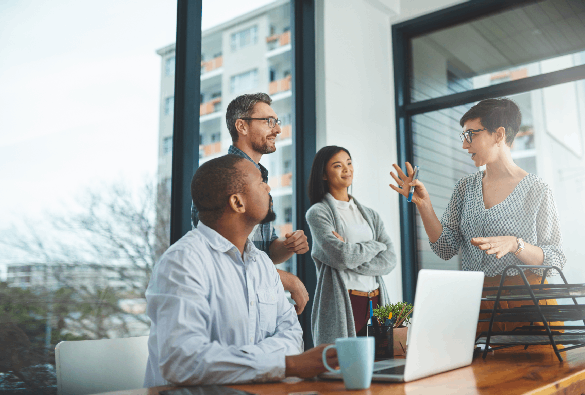 Professionals discussing ideas during a team meeting in a modern office.