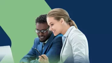 a woman and a man looking at a computer