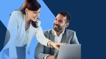 a women and a man pointing a computer