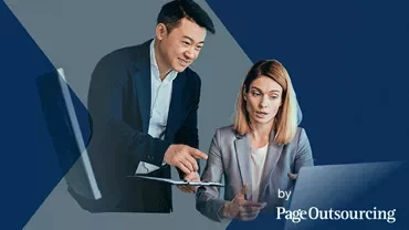 a woman and a man pointing to a computer and talking about it