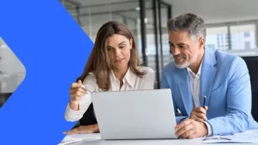 two coworkers looking at a computer