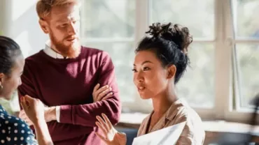 a group having a conversation in a luminous room 