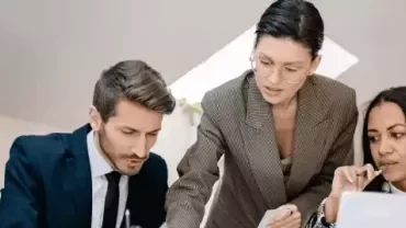 Team reviewing documents together at a workplace.