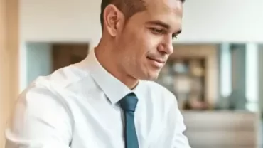 Professional working at a desk in a modern office environment.