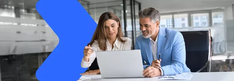 two coworkers looking at a computer