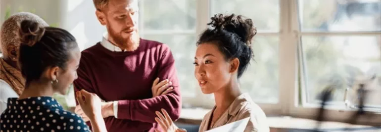 a group having a conversation in a luminous room 