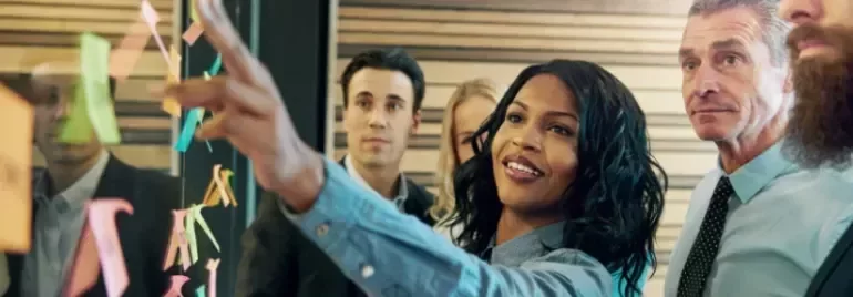 Team collaborating with sticky notes during a brainstorming session.