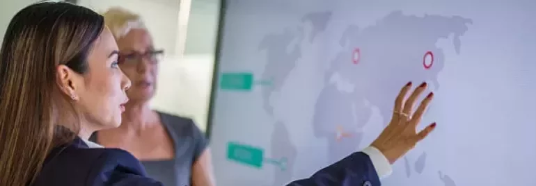 a woman pointing to a map