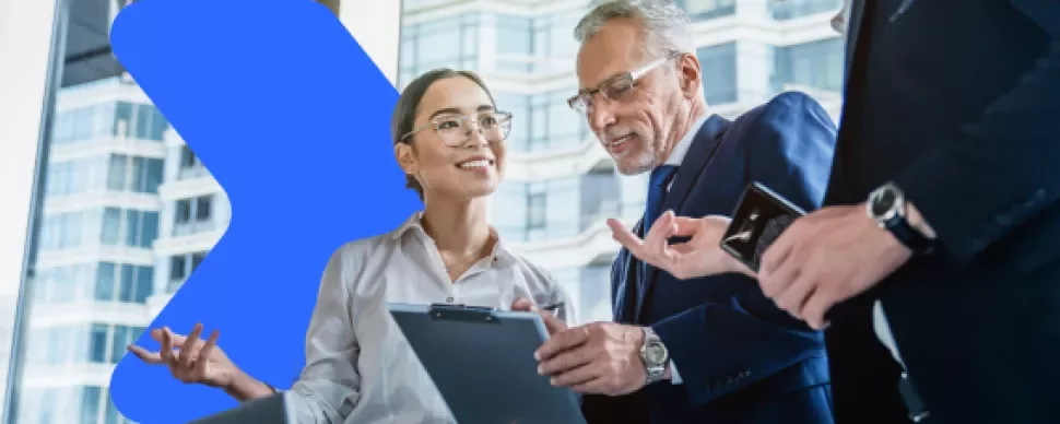 three coworkers looking at a tablet